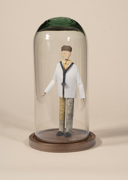 Doctor de origami con bata blanca, en capelo de vidrio sobre base de madera