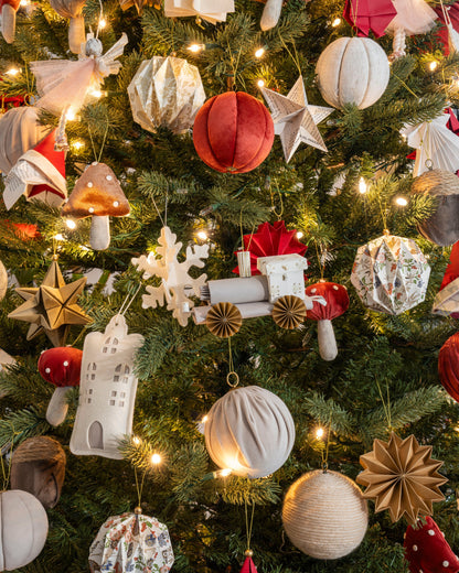 Árbol de Navidad con esfera de estambre beige entre esferas de terciopelo y papel